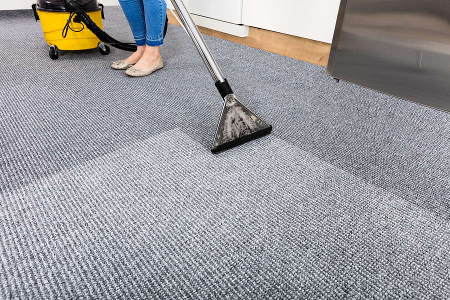 Close-up Of A Cleaning Carpet With Vacuum Cleaner
